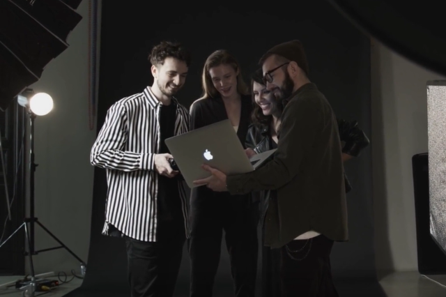 imagen de un grupo de 4 personas trabajando y viendo una laptop Mac
